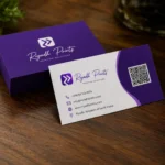 Premium Riyadh Prints business cards displayed on a wooden desk with purple branding and professional print finish.